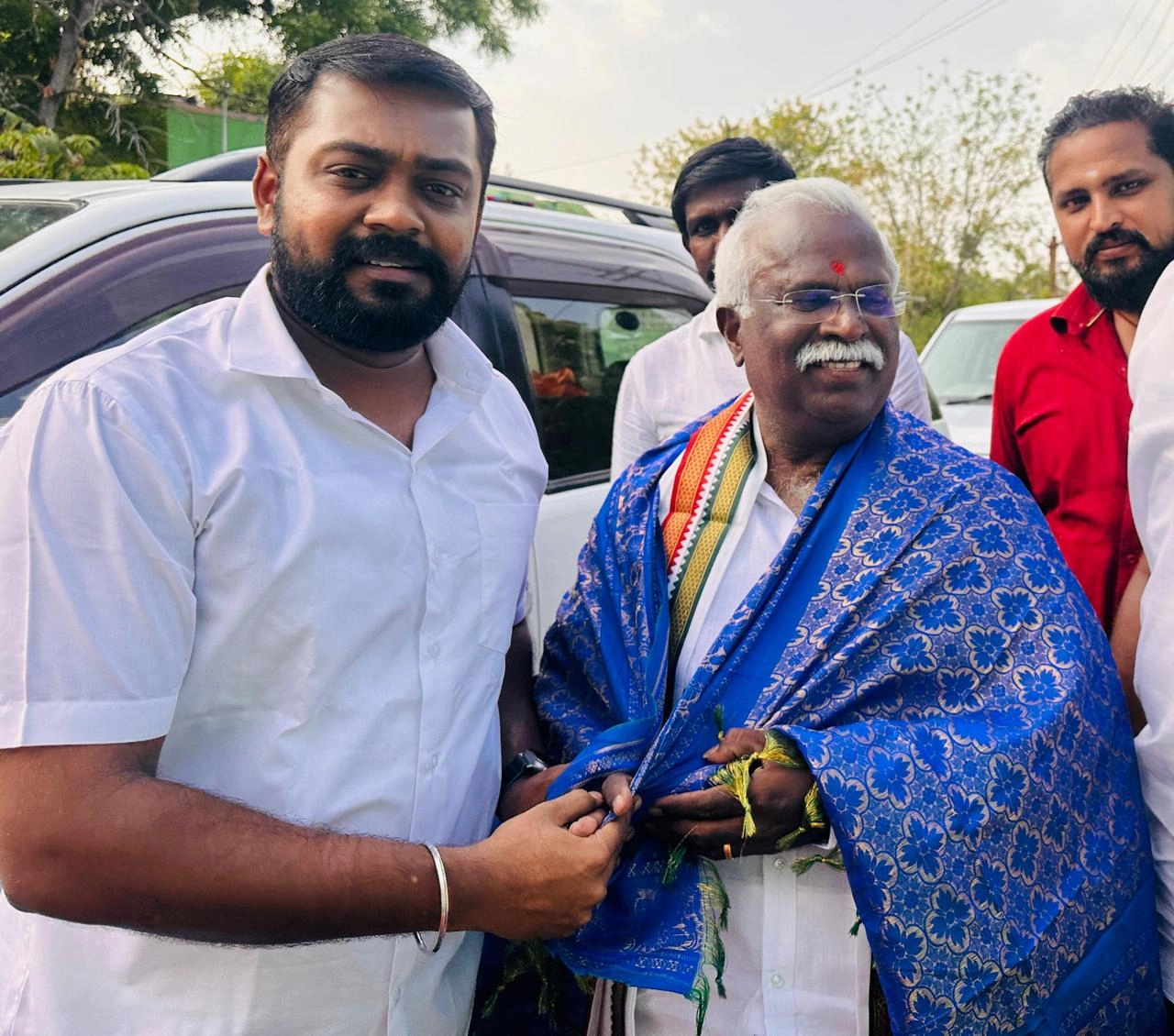 T.R. Krishnaraja and DMK Youth Wing members distributing campaign flyers during 2024 election